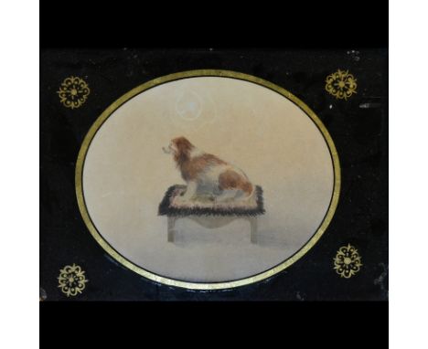 English School,first half 19th Century,Spaniel on a stool,watercolour, oval,11cm x 14cm,in a verre-eglomise mount.