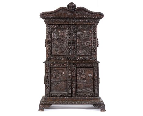 The Shakespeare cabinetCarved and stained oak cabinet, late 19th Century incorporating older elements, cornice with a mask he