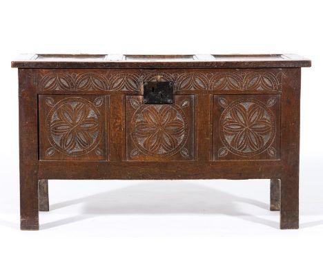Joined oak coffer, early 18th Century, three panel hinged lid, front fascia carved with lunettes to the frieze, the panels wi