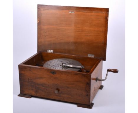 Table-top Symphonium, playing 20cm discs, walnut veneered case, with transfer printed decoration to the lid, width 42cm, with