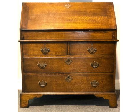Oak bureau, by Haselbech Oak, fall front enclosing a well fitted interior, with stepped drawers, central cupboard and a well 