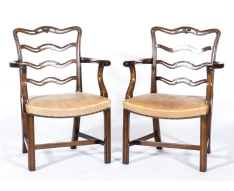 Set of six George III style mahogany elbow chairs, each with pierced wavy ladder backs, scrolled arms, close studded leather 