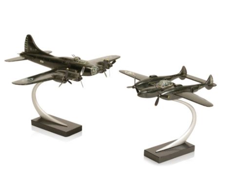 CARVED AND PAINTED SCALE MODEL OF A LOCKHEED P-38 LIGHTNING on a curved chrome stand and wooden base, 37cm wide; together wit