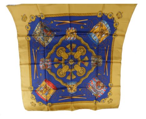 HERMES 'LES TAMBOURS' SILK SCARF, designed by Joachim Metz. Released 1989. Royal blue background with gold border depicting r