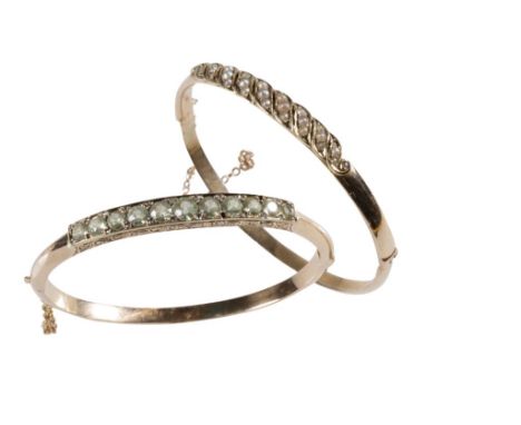 GEM-SET AND DIAMOND BANGLE, set to the centre with eleven graduating pale green gem-stones, with old-cut diamond dividers, on
