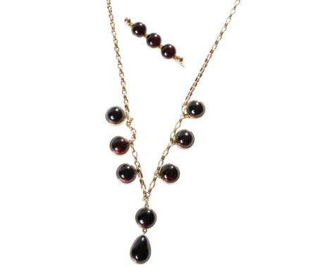 GARNET AND UNMARKED YELLOW GOLD NECKLACE, seven round cabochon garnets, the centre garnet with an attached pear shaped drop, 