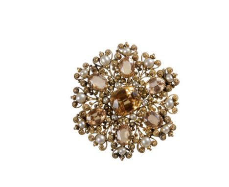 IN THE MANNER OF CASTELLANI: A VICTORIAN YELLOW GOLD FILIGREE TARGET BROOCH set with seven "sherry tourmaline" and numerous s