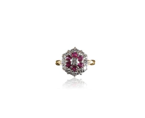 RUBY AND DIAMOND CLUSTER RING, the centre brilliant-cut diamond approximately 0.15ct, surrounded by a border of six rubies, a