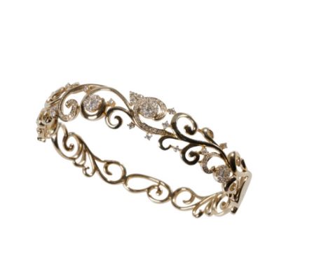 DIAMOND AND YELLOW GOLD BANGLE, the scroll worked hinged bangle, set to the front with micro-set diamonds, the concealed clas