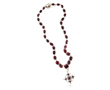 19TH CENTURY GARNET NECKLACE, each graduating flat garnet set on unmarked yellow metal ,chain linked, with concealed clasp an