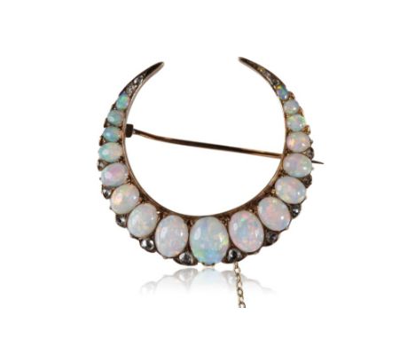 OPAL AND DIAMOND CRESCENT BROOCH, seventeen graduating oval-cut opals, interspersed with old cut diamonds, set on unmarked ye