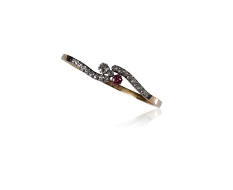 DIAMOND AND RUBY BANGLE, two shaped rows of nine pave' set diamonds joined to the centre by a claw-set diamond approximately 