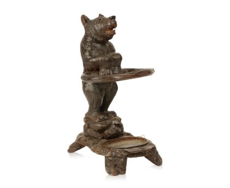 ATTRIBUTED TO THE TRAUFFER FAMILY: A SWISS 'BLACK FOREST' TYPE CARVED WOOD BEAR STICK STAND with inset glass eyes, modelled s