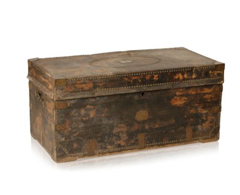 LARGE LEATHER COVERED AND BRASS BOUND TRUNK the body with all over studwork decoration, the lifting top centred with an oval 