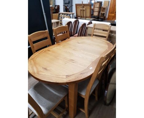 SUPERB OAK EXTENDING OVAL TABLE TOGETHER WITH 6 MATCHING UPHOLSTERED LADDER BACK CHAIRS