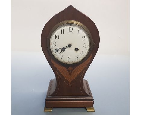 Mahogany balloon shaped mantle clock with winged inlay design.