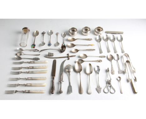 A collection of flatware, to include two Georgian silver spoons, a Victorian silver spoon, tea spoons, sugar tongs, napkin ri