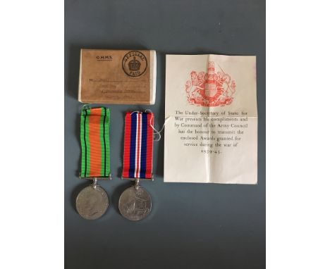 World War Two Defence and Victory medals, belonging to R Moss, with postage box and letter.