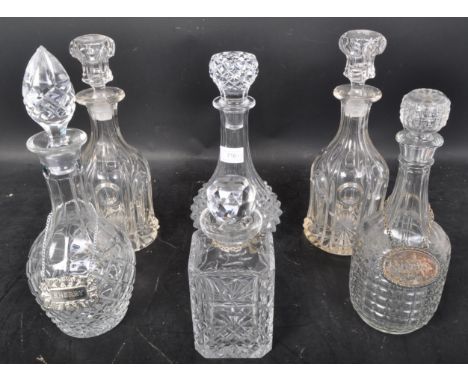 A collection of 19th and 20th century cut glass decanters to include acid etched examples,ships and bell decanters, Complete 