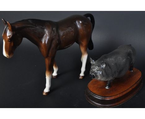 A collection of vintage 20th century china animal figures to include a Royal Doulton pig figure on wooden base, a Beswick man