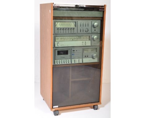 A vintage 20th Century cased music stereo system. The system being teak cased housing an Amstrad stereo tuner, cassette deck 