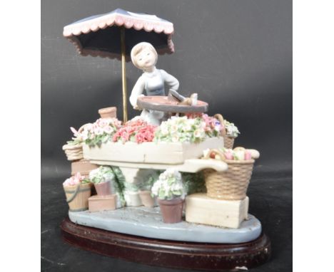 Lladro porcelain figurine&nbsp; - Flowers of the Season. Porcelain diorama figurine of a girl flower seller before card of en