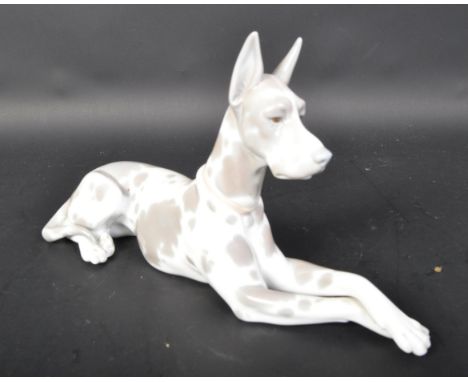 Lladro - Spanish hand made porcelain - A figurine statue of a Great Dane dog in the lying down position. Grey and white colou