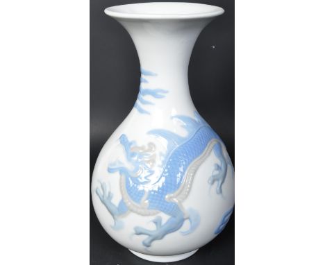 A 20th century Lladro porcelain vase having white ground with blue detailing dragon. Marked Lladro to the base with incised m