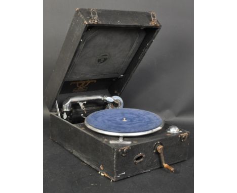 An early 20th century HMV portable manual gramophone. The portable complete with handle contained in a black fibre carrying c
