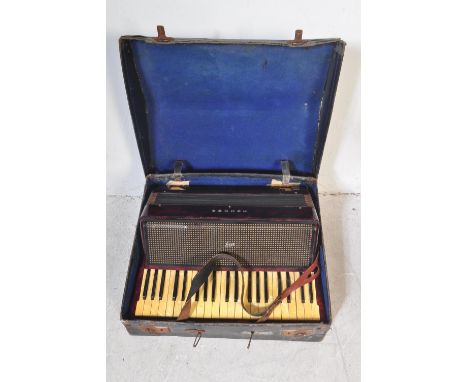 A vintage 20th century circa. 1940's Hohner accordion musical instrument having red Lucite type case and cream bellows, Held 
