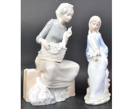 Lladro &amp; Nao - Two vintage 20th century Spanish porcelain figurines to include a Lladro figure D-22 4972 Girl Sitting wit