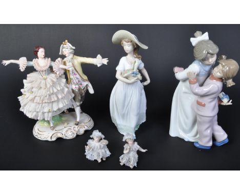 An assortment of 20th century Dresden German porcelain lace figurines comprising of a couple dancing, together with two minia