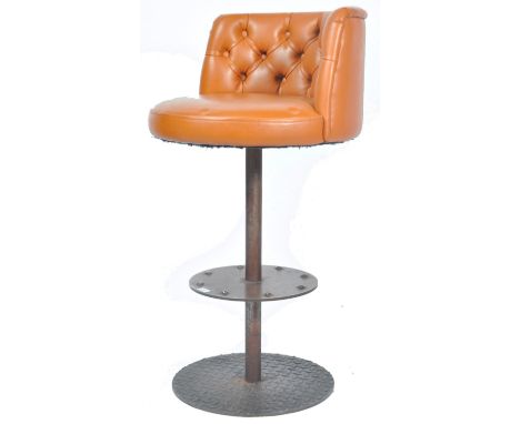 A vintage late 20th Century American style leather bar / cafe swivel stool having a tan brown leather button back seat raised