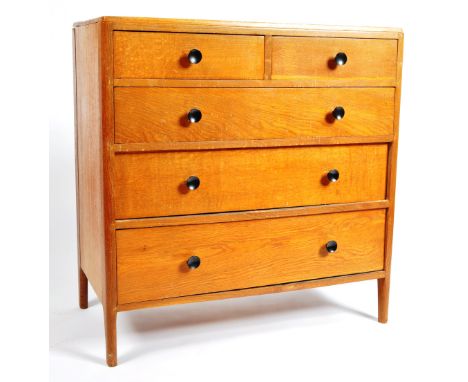 A vintage early to mid 20th Century English Air Minitsary light oak chest of drawers having a configuration of two over three