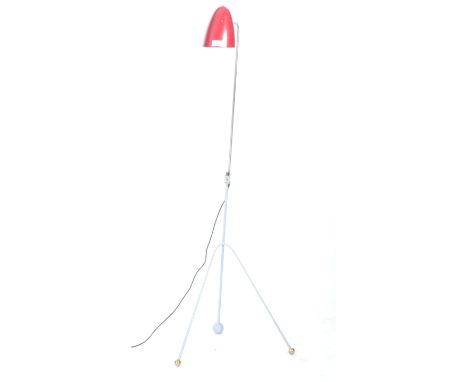 A retro vintage 20th Century French floor standing tripod standard lamp light having a red aluminium conical shade raised upo