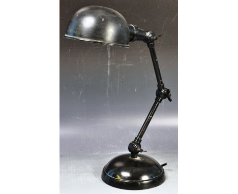 A retro vintage 20th Century Industrial factory work desk lamp having a black enamel shade with twin adjustable arm raised on