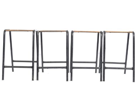 A set of four retro vintage mid 20th Century 1950's stacking Industrial scientific lab stools having beech wood panel seats s