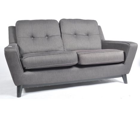 G Plan - A contemporary retro English two seater sofa settee from the Vintage Line. Upholstered in a charcoal grey with a but