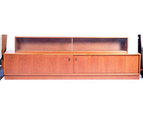 A large retro vintage mid 20th Century Danish teak wood low sideboard credenza / Hi - Fi record cabinet having a sliding doub