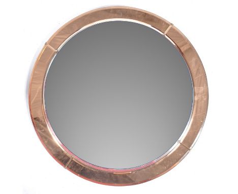A retro vintage 20th Century circular hanging wall mirror having a bevelled edge mirror panel with further coloured copper to