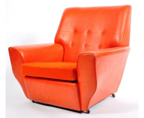 A vibrant retro vintage 20th Century faux leather armchair / club arm chair having an eye catching orange faux leather vinyl 