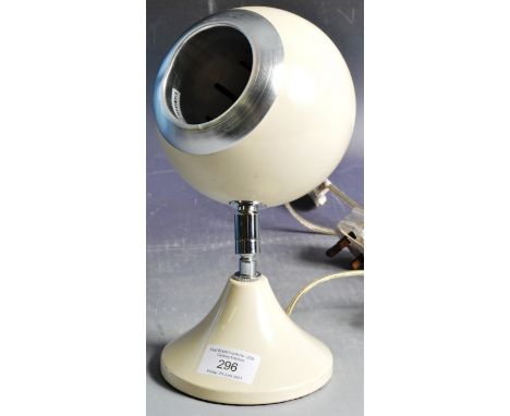 A contemporary retro vintage style Eyeball / Eye Ball shape work desk lamp light in a cream enamel finish with chrome mounts 