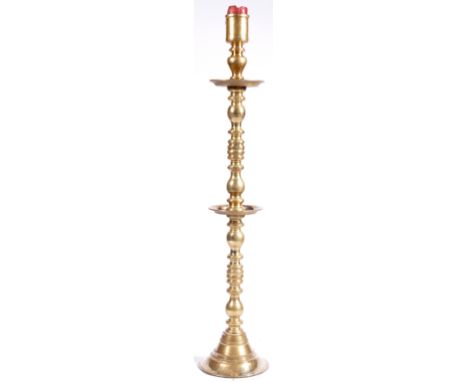 A large and impressive antique style Dutch heavy brass pillar / floor standing candlestick having a candle sconce to top with