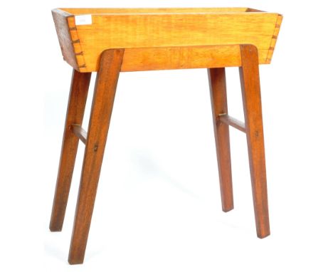 A retro vintage 20th Century teak &amp; oak wood planter having a rectangular plant holder section raised on angular 'A' fram