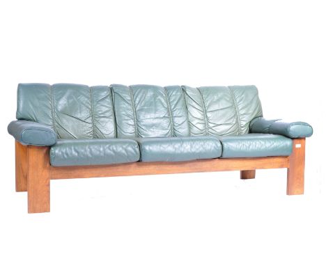 Ekornes - A retro vintage 20th Century Norwegian teak and leather upholstered three seater sofa settee having thick teak show