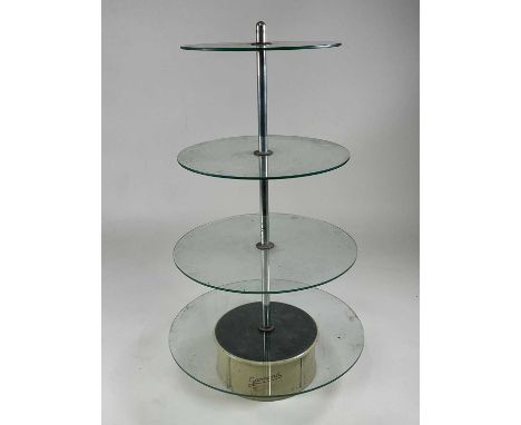 A 1930s Garrard revolving four tier shop display stand, the electric motor powered revolving base within a circular enamel ca
