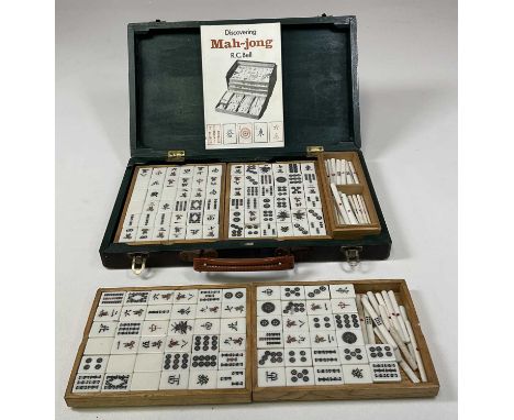 A cased Mahjong set, together with a Discovering Mahjong booklet