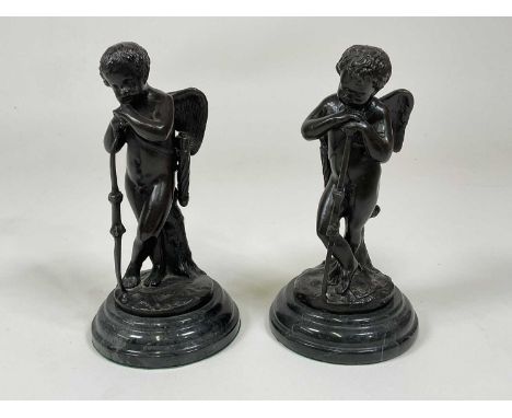 AFTER AUGUSTE MOREAU; a pair of bronze putti (Cupid) figures leaning on their bows, mounted on a circular granite base, heigh