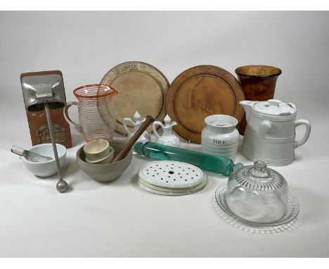 A quantity of kitchenalia including glass rolling pin, pestle and mortars, storage jar, glass cheese dome, bread boards etc.