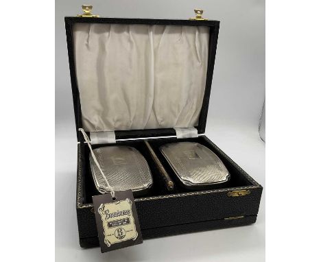 BROADWAY &amp; CO; a cased Elizabeth II hallmarked silver three piece dressing table set comprising pair of brushes and comb,